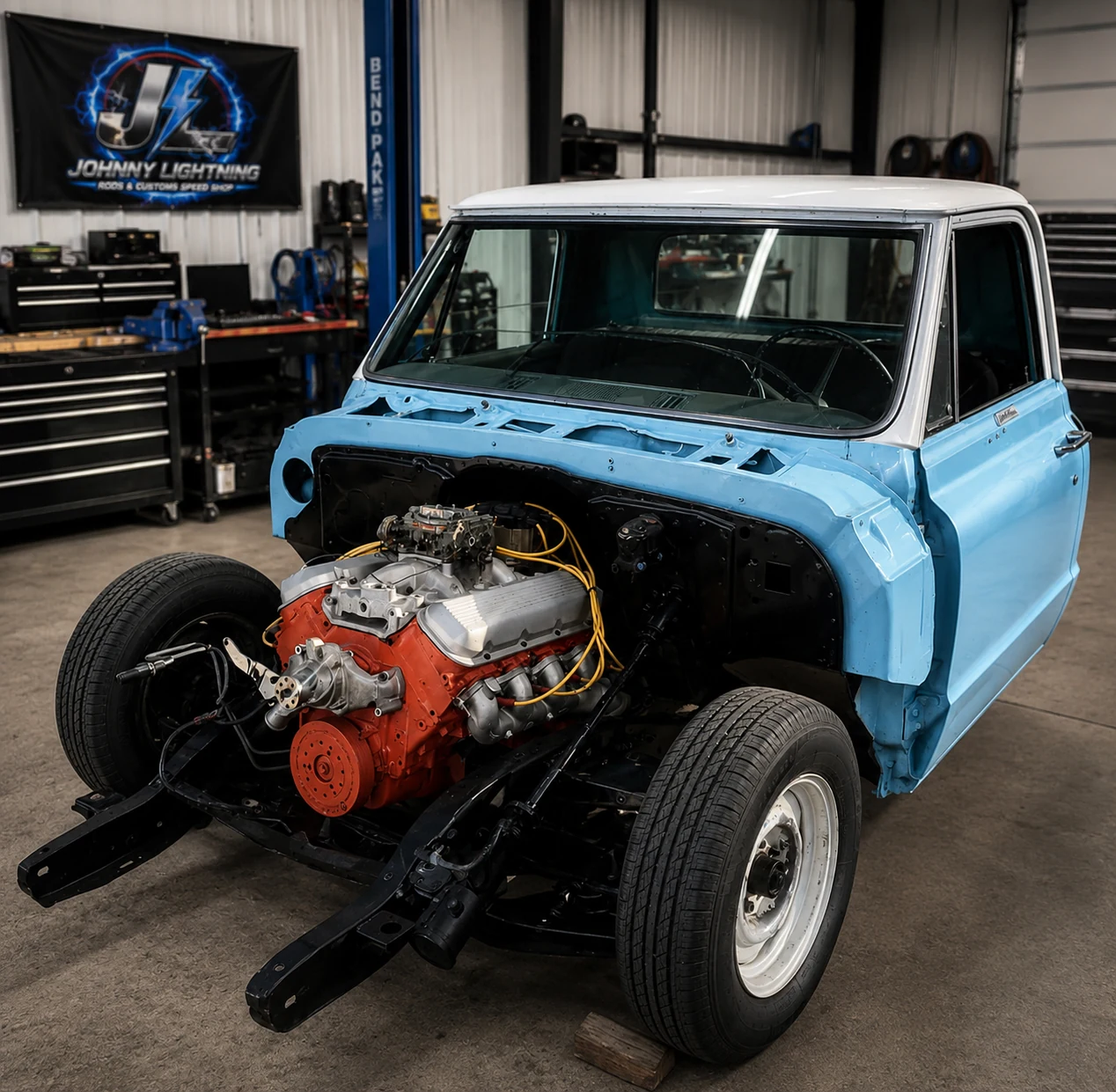Hard Time C10 with the front end removed, showing the engine and chassis inside the shop